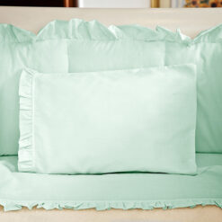 Juego de sábanas verde con boleros para cuna